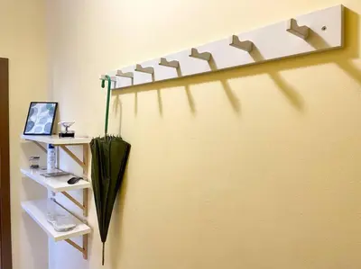 an umbrella sitting on a wall next to a shelf at 35 Cozy Central 1 Bedroom Apartment with Balcony in Sofia