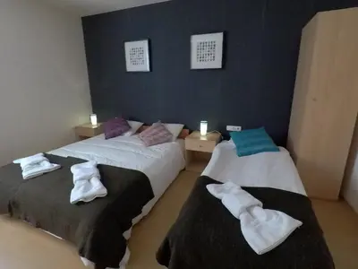 two beds with towels on them in a room at Monastery Apartment C39 in Bansko