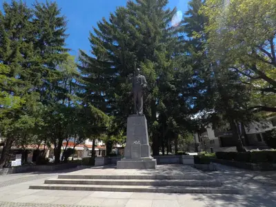 a statue of a man on a pedestal in a park at Monastery Apartment C39 in Bansko