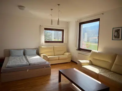 a living room with two couches and a coffee table at Вила и тенис комплекс ,,Синьото
