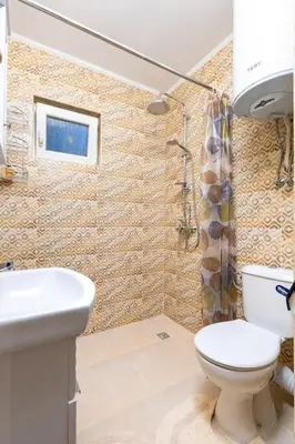 a bathroom with a toilet and a sink at Central apt 'SELIN' Walking distance to center in Plovdiv