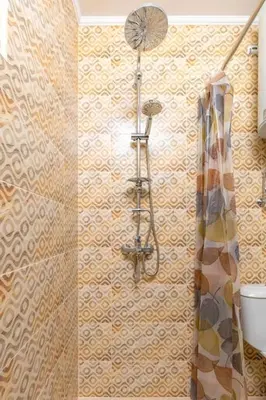 a shower in a bathroom with ailed wall at Central apt 'SELIN' Walking distance to center in Plovdiv
