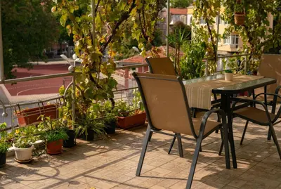 a table and chairs on a patio with plants at 2-Bedroom Flat - Sunny Balcony in Plovdiv