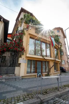 a building with an umbrella in front of it at 2-Bedroom Flat - Sunny Balcony in Plovdiv