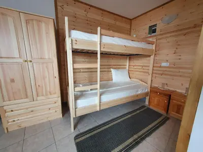 a room with two bunk beds in a cabin at ЕДЕЛВАЙС Сърница in Sarnitsa