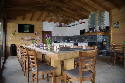 a large kitchen with a large wooden table and chairs at ЕДЕЛВАЙС Сърница in Sarnitsa
