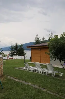 a group of white chairs sitting in the grass at ЕДЕЛВАЙС Сърница in Sarnitsa