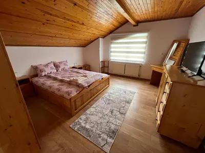 a bedroom with a bed and a television in a room at ЕДЕЛВАЙС Сърница in Sarnitsa