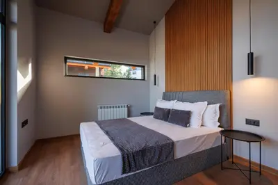 a bedroom with a bed and a window at Local Stay Villas in Bansko