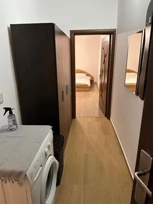 a small room with a washing machine and a hallway at Апартамент Бояна in Plovdiv