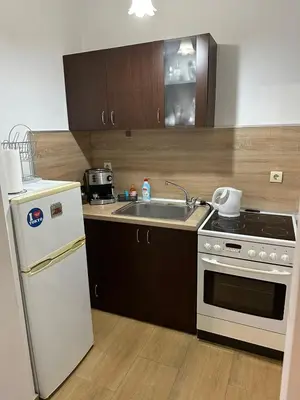 a kitchen with a white refrigerator and a sink at Апартамент Бояна in Plovdiv