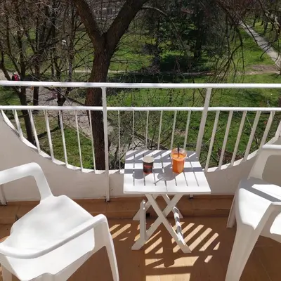 a white balcony with a table and chairs on it at Апартамент Бояна in Plovdiv