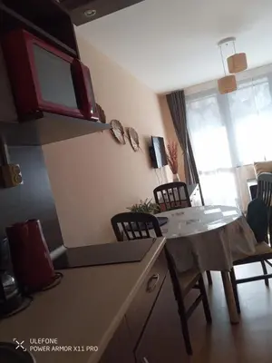 a kitchen with a table and chairs in a room at studio royal park bansko in Bansko