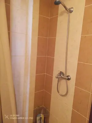 a shower with a shower head in a bathroom at studio royal park bansko in Bansko