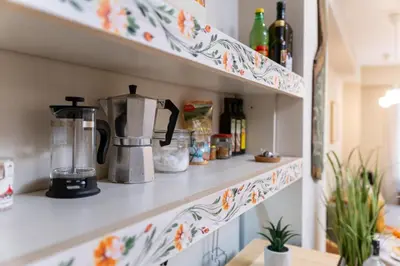 a kitchen shelf with a flowery pattern on it at Chic Urban Getaway in City Center by Flat Mаnager in Plovdiv