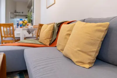 a blue couch with several pillows on it at Chic Urban Getaway in City Center by Flat Mаnager in Plovdiv