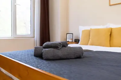 a bedroom with a bed with two towels on it at Chic Urban Getaway in City Center by Flat Mаnager in Plovdiv
