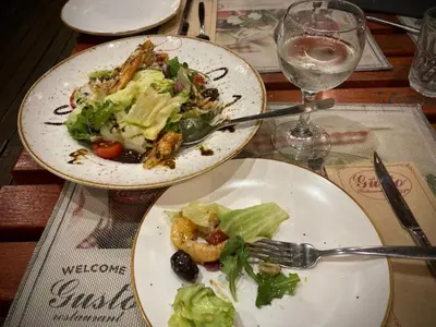 two plates of food on a table with a salad at Chic Urban Getaway in City Center by Flat Mаnager in Plovdiv