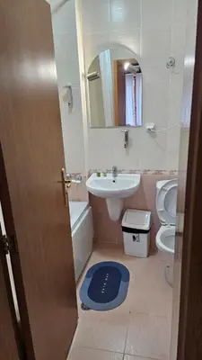 a bathroom with a sink and a toilet and a mirror at Aparthotel Raikov Ski Lodge in Pamporovo
