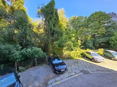 two cars parked in a parking lot next to trees at Casa Rea - Comfortable Stay with Free Parking in Sofia