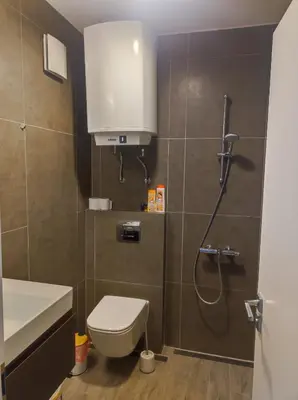 a bathroom with a shower with a toilet and a sink at Апартамент Pavlin in Plovdiv