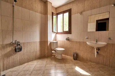 a bathroom with a toilet and a sink at Вълеви Къщи in Chiflik