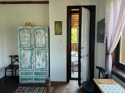 an old glass cabinet in a room with a door at Guest House Opa in Smolyan