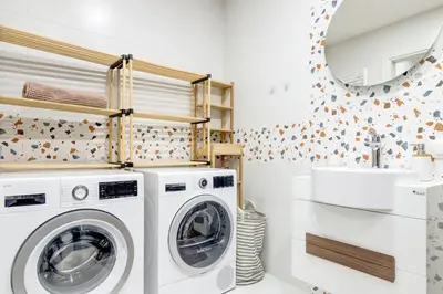 a laundry room with a washing machine and a sink at Luxury 2 BDRM Getaway and Free Parking in Sofia
