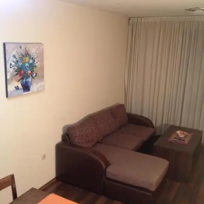 a living room with a couch and a table at Ski Lift Apartment in Bansko in Bansko