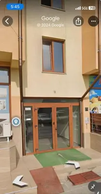 a building with glass doors on the side of it at Apartment Yana- The Amazing View in Smolyan