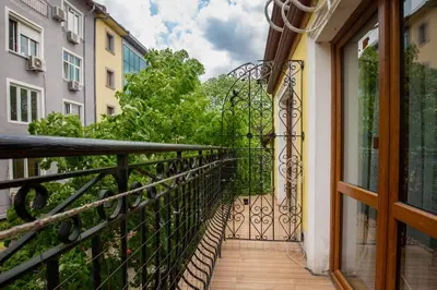 a balcony with a wrought iron fence and trees at Nova Guesthouse - Private En-Suite Rooms I Sofia Center I Self Check-In in Sofia