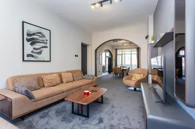 a living room with a couch and a table at Urban Elegance Apartment in Sofia