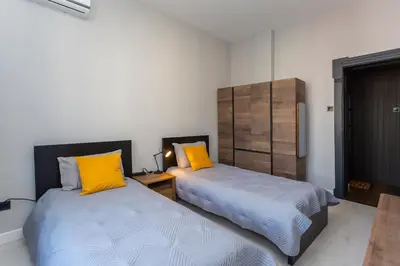two beds sitting next to each other in a room at Urban Elegance Apartment in Sofia