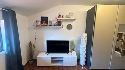 a living room with a tv on a white cabinet at Ski Nomad Bansko in Bansko
