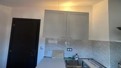a kitchen with a sink and a cupboard at Ski Nomad Bansko in Bansko