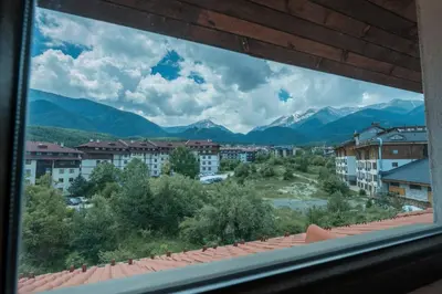 a view from a window of a city with mountains at Ski Nomad Bansko in Bansko