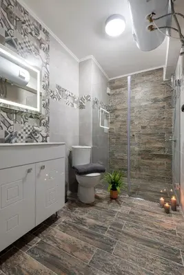 a bathroom with a toilet and a walk in shower at Best Guest 2 Apartments in Plovdiv