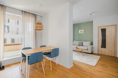 a living room with a table and chairs and a couch at Modern and Central 1BD Flat with Balcony by Flat Mаnager in Sofia