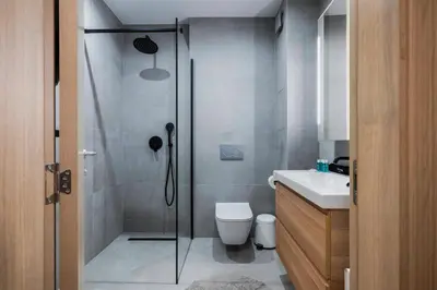a bathroom with a shower and a toilet and a sink at Modern and Central 1BD Flat with Balcony by Flat Mаnager in Sofia