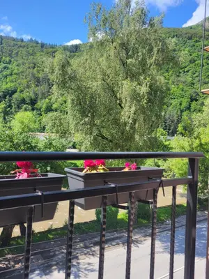 a balcony with two flowerpots on a railing at Luxury apartment in Teteven