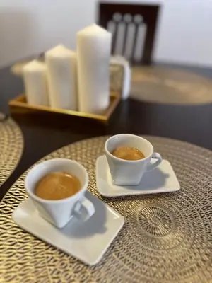 two cups of coffee sitting on a table at MonarX Suites in Bansko