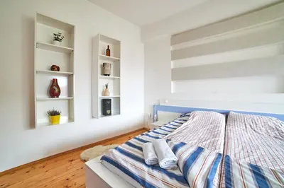 a bedroom with a bed with towels on it at Main Street Sunshine 2 KING Bdr in Sofia