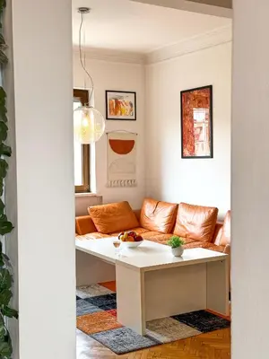 a living room with a couch and a table at Main Street Sunshine 2 KING Bdr in Sofia