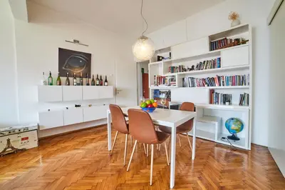 a dining room with a white table and chairs at Main Street Sunshine 2 KING Bdr in Sofia