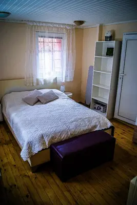 a bedroom with a large bed and a window at NIKI Apart in Sofia