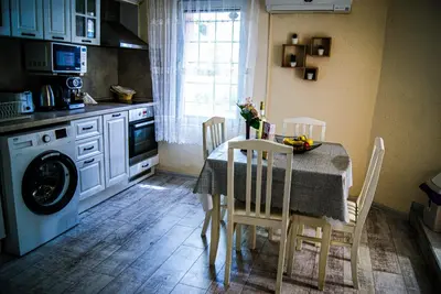 a kitchen with a table and chairs and a kitchen with a sink at NIKI Apart in Sofia