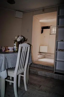 a white chair sitting at a table in a room at NIKI Apart in Sofia