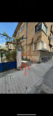 a orange table on a sidewalk in front of a building at NIKI Apart in Sofia