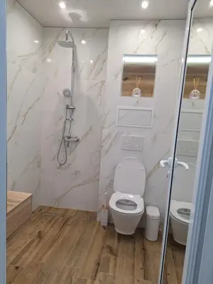 a white bathroom with a shower and a toilet at Sandanski park view in Sandanski