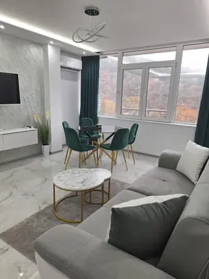 a living room with a couch and a table at Sandanski park view in Sandanski